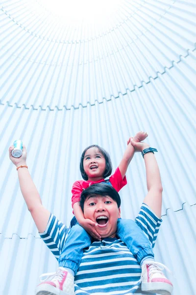 asian boy playing with his little baby girl