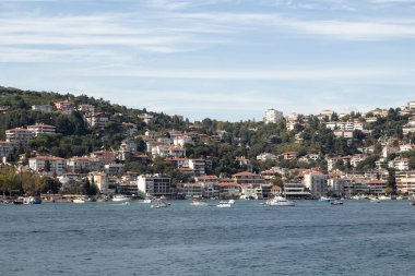 View of moored yachts on Bosphorus and Bebek neighborhood on European side of Istanbul. It is a sunny summer day. Beautiful travel scene.
