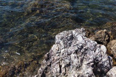 Top view of volcanic rocks by Aegean sea captured near Ayvalik town in Turkey.
