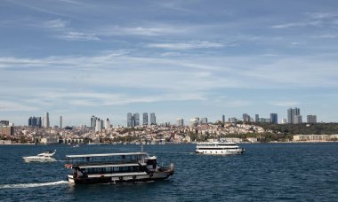 View of tour boats on Bosphorus and European side of Istanbul. It is a sunny summer day.