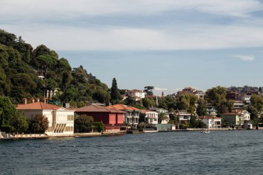View of historical, traditional mansions by Bosphorus in Anadolu Hisari area of Asian side of Istanbul. It is a sunny summer day. Beautiful travel scene.