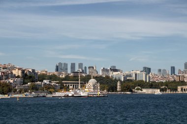 View of ferry boats, historical mosque and European side of Istanbul. It is a sunny summer day.