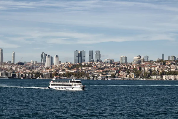 View of a cruise tour boat on Bosphorus and European side of Istanbul. It is a sunny summer day.