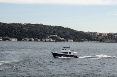 View of a boat on Bosphorus and Asian side of Istanbul. It is a sunny summer day. Beautiful scene.