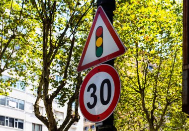 Close up view of traffic signs with trees in the background in Istanbul.