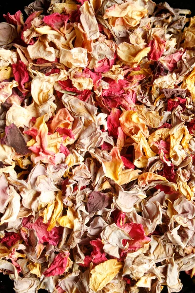 Background: dried rose petals spread on the table top