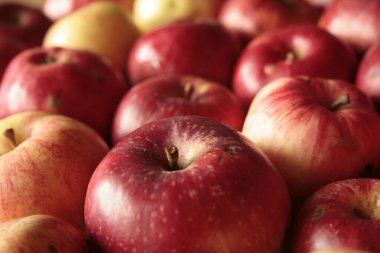 Background: red apples spilled on the table top