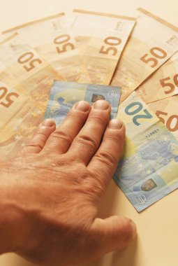 palm on banknotes lying on the table