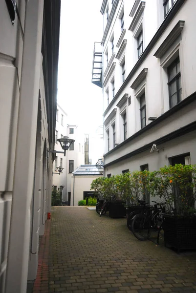 A city arcade with bright houses, greenery and bicycles
