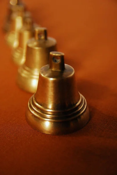 The row of bells laid out on the table top