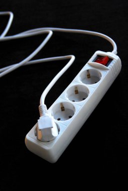 Electric extension cord on a black background