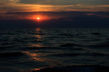 Deniz sahilinde gün batımı, akşam, ufukta