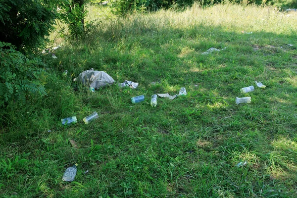 plastic bottles on the grass, garbage, pollution