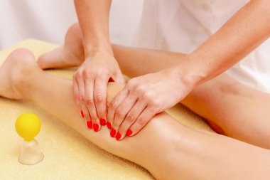 Young woman getting a massage at the spa. Body care. Therapeutic foot massage in the spa salon. Skin care, well-being.