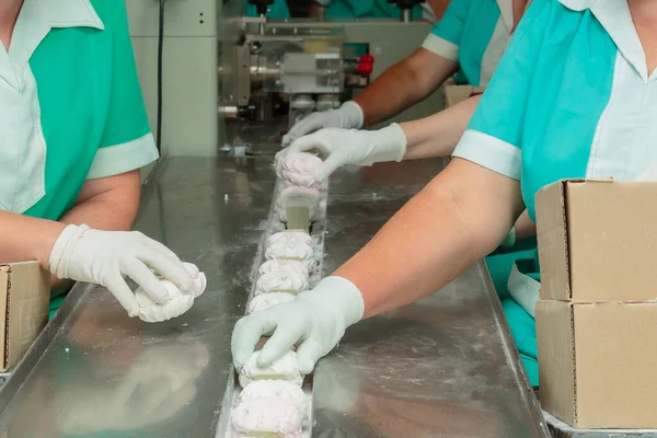 Confectionery factory. Production of confectionery products. Packaging of marshmallows.