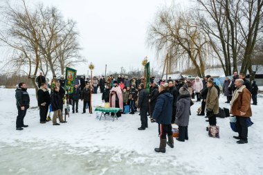 Ukraine, city of Romny, January 19, 2013: Procession of the Holy Cross to the baptismal font on the feast of the Baptism of the Lord. Epiphany. Feast of the Baptism of the Lord