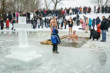 Ukraine, the city of Romny, January 19, 2013: the feast of the Baptism of the Lord. Orthodox rite of bathing in the ice hole. Epiphany. Many people come to swim in the winter river