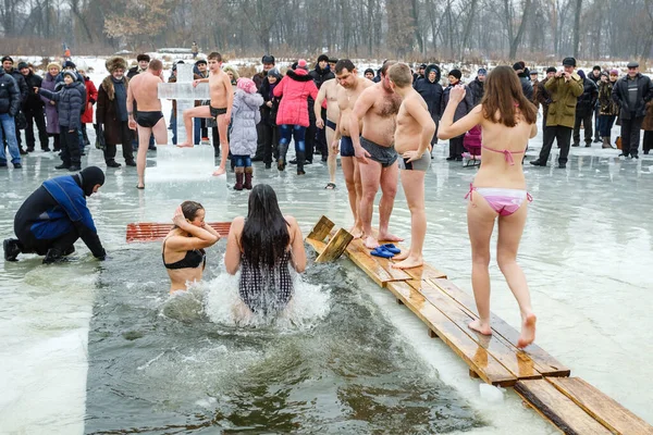 Ukraine, the city of Romny, January 19, 2013: the feast of the Baptism of the Lord. Orthodox rite of bathing in the ice hole. Epiphany. Many people come to swim in the winter river