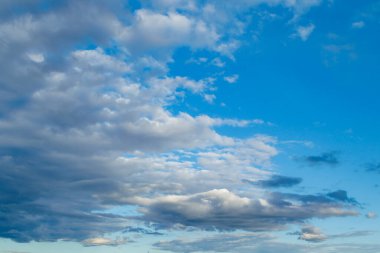 The moon and clouds in the blue evening sky. Natural background photo texture.