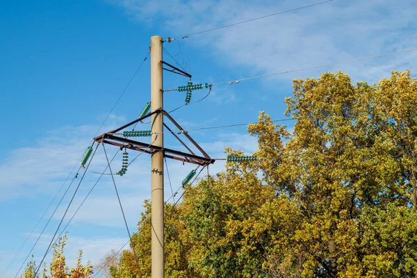 Mavi gökyüzünün arka planında yakın plan elektrik hatları var. Direkte elektrik merkezi. Yüksek voltaj kabloları.