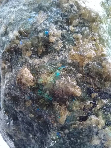 Close-up of jade and other minerals in an uncut stone