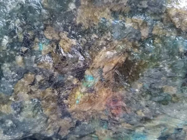Close-up of jade and other minerals in an uncut stone