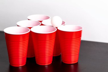 Red solo cups set up for the drinking game beer pong on a white background