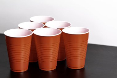 Red solo cups set up for the drinking game beer pong on a white background