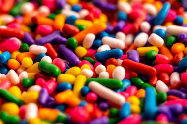 Rainbow sprinkles including yellow, orange, red, pink, purple, blue, green, and white
