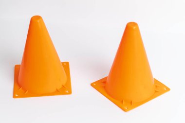Orange cone potentially used for traffic on a white background