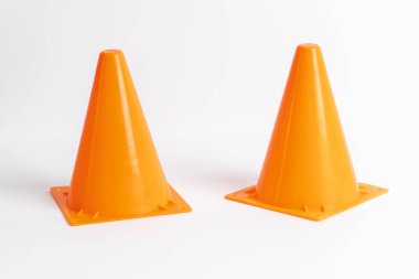 Orange cone potentially used for traffic on a white background