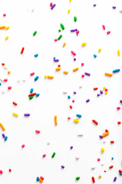 Rainbow sprinkles including yellow, orange, red, pink, purple, blue, green, and white