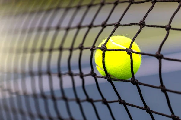 Tennis ball hitting the net for a fault