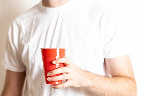 Person Holding Red Disposable Party Cup White Background - Stock-foto
