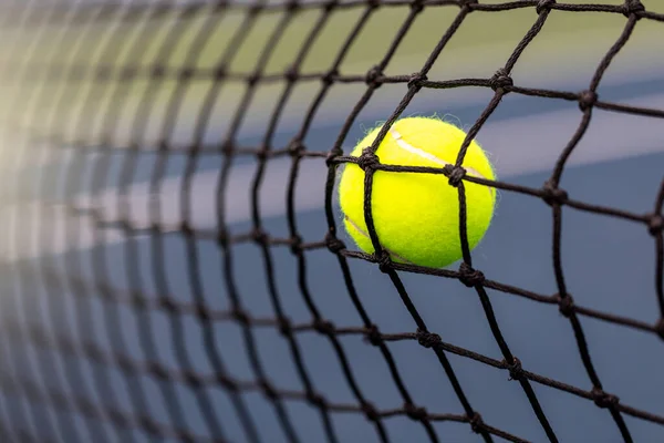 Tennis ball hitting the net for a fault