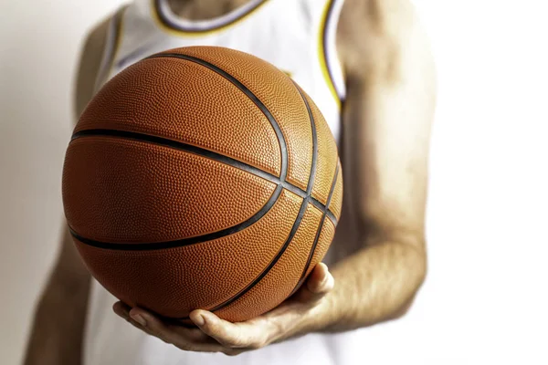 Male holding a basketball in his hand on a white background
