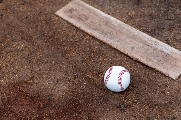 Baseball laying in the dirt at the pitcher's mound