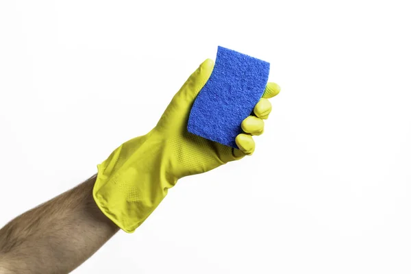 Blue cleaning sponge in a hand against a white background