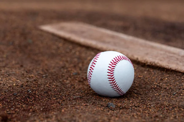 Baseball laying in the dirt at the pitcher's mound