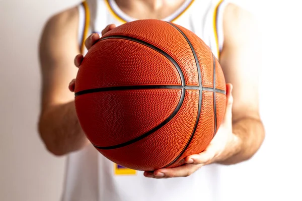 Male holding a basketball in his hand on a white background