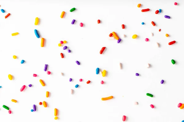 Rainbow sprinkles including yellow, orange, red, pink, purple, blue, green, and white