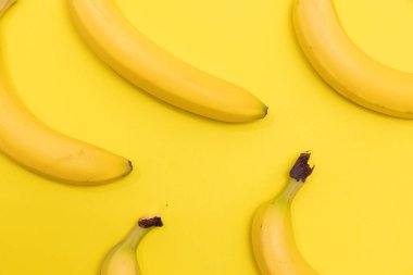 Group of bananas shot on a yellow background