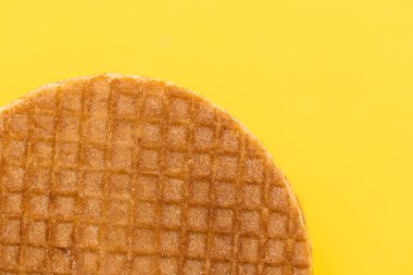 Stroopwafel cookies or biscuits on a gold or yellow background