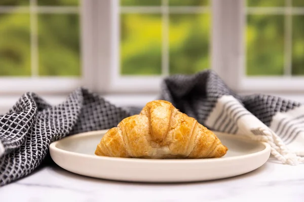Flaky and baked croissant in a kitchen scene