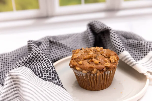 Banana nut muffin shot in a kitchen scene