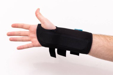 Wrist brace on a broken or sprained wrist on white background