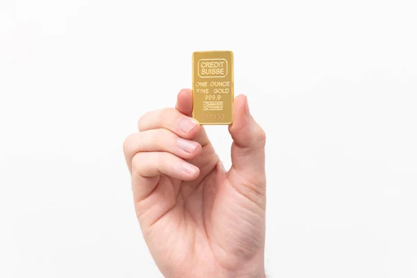 One ounce of solid gold on a white background