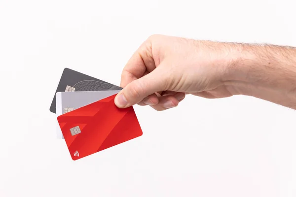 Credit cards being held up against a white background