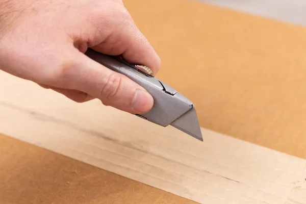 Box cutter that is silver with the blade out
