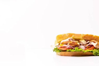 Freshly made sandwich with turkey, tomato, lettuce, and onion